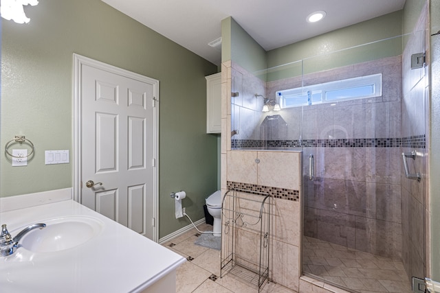 bathroom with vanity, toilet, a shower with door, and tile patterned flooring