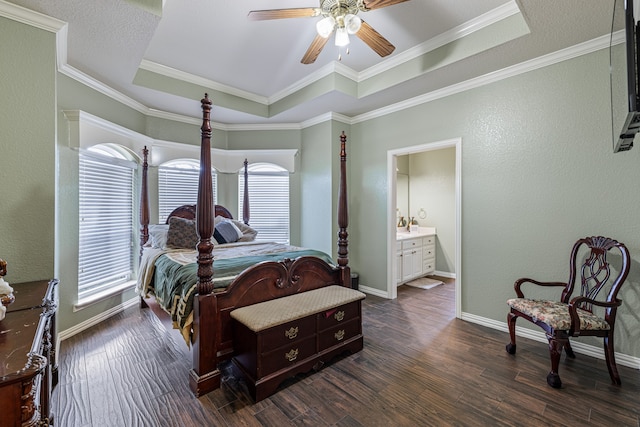 bedroom with a raised ceiling, dark hardwood / wood-style flooring, ornamental molding, and ceiling fan