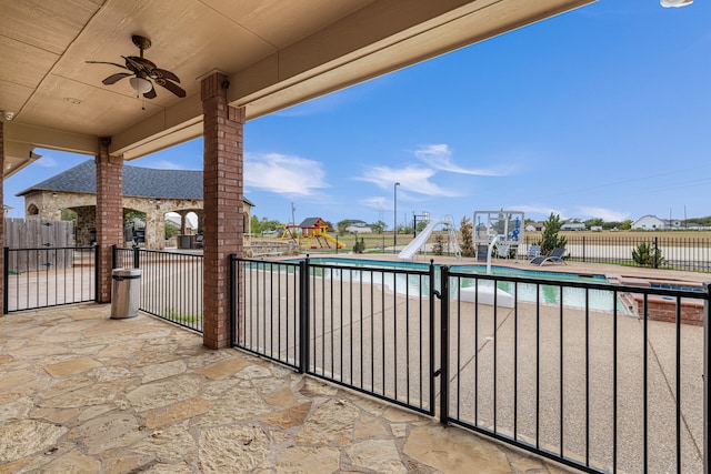 view of patio featuring ceiling fan and a fenced in pool