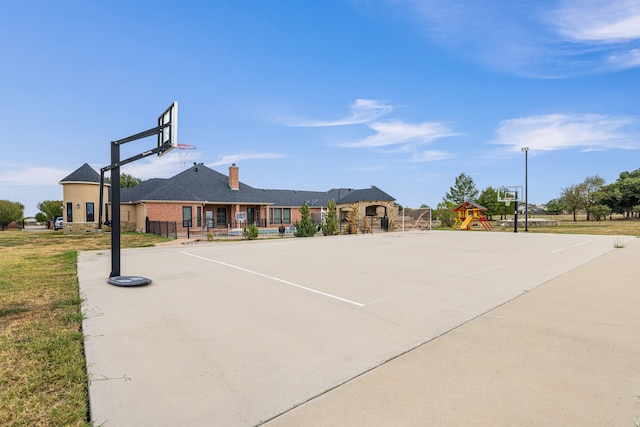 view of basketball court featuring a playground