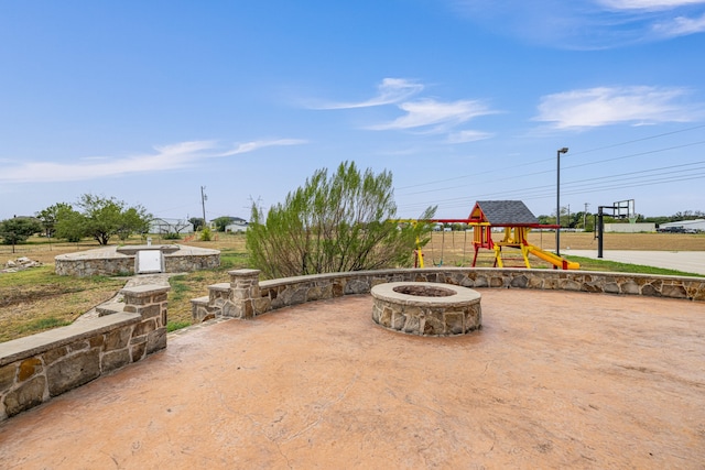 view of patio / terrace featuring a fire pit and a playground