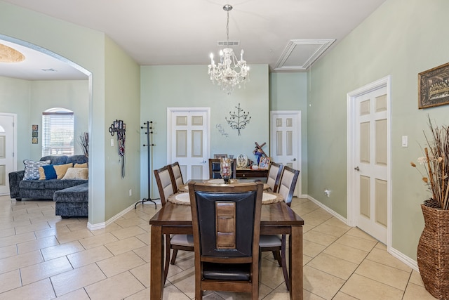 dining area featuring a notable chandelier and light tile patterned floors