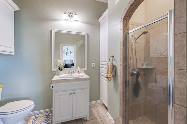 bathroom with vanity, tile patterned floors, an enclosed shower, and toilet