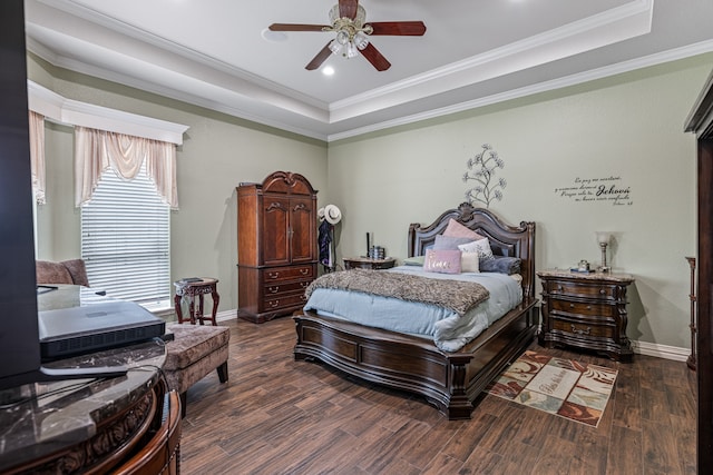 bedroom featuring a raised ceiling, crown molding, hardwood / wood-style floors, and ceiling fan