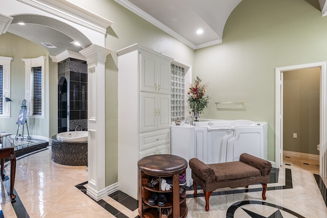 living area with ornamental molding, decorative columns, and light tile patterned floors