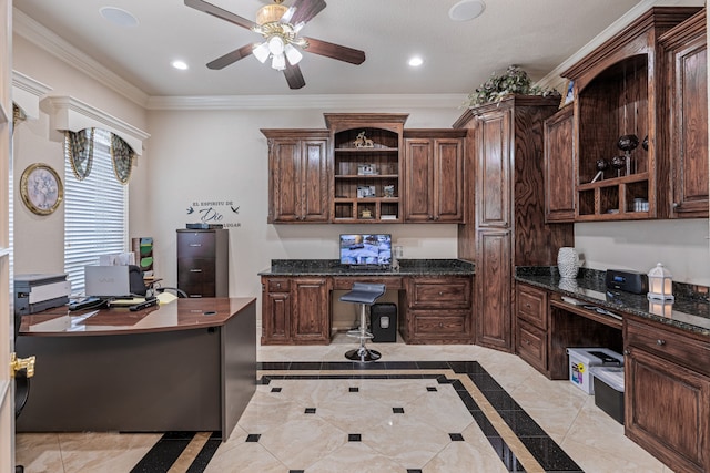 tiled office space featuring built in desk, ornamental molding, and ceiling fan