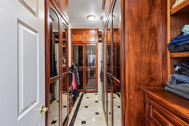 spacious closet featuring light tile patterned floors