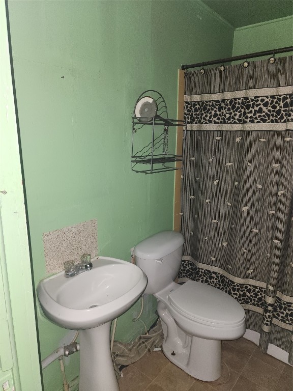 bathroom with tile floors and toilet