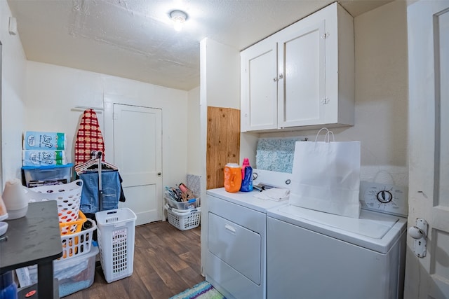 laundry room with dark hardwood / wood-style floors, cabinets, and washing machine and dryer