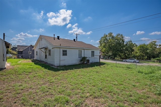 rear view of house with a yard