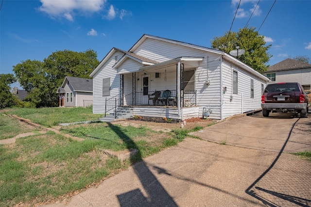 view of front of house with covered porch and a front yard