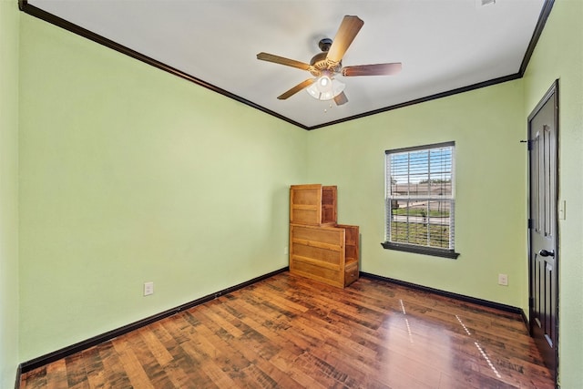 empty room with crown molding, dark hardwood / wood-style floors, and ceiling fan