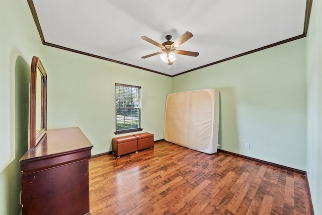 interior space featuring dark hardwood / wood-style floors, ceiling fan, and ornamental molding