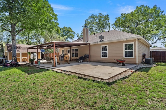 back of house featuring a lawn and a patio