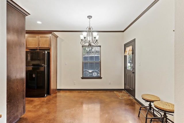 kitchen featuring crown molding, a notable chandelier, decorative light fixtures, and black fridge