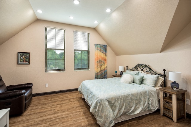 bedroom with hardwood / wood-style floors and vaulted ceiling