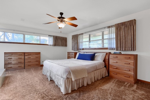 bedroom featuring carpet, multiple windows, and ceiling fan