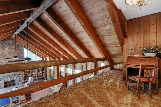 additional living space with ceiling fan, a stone fireplace, lofted ceiling with beams, wooden walls, and wood ceiling