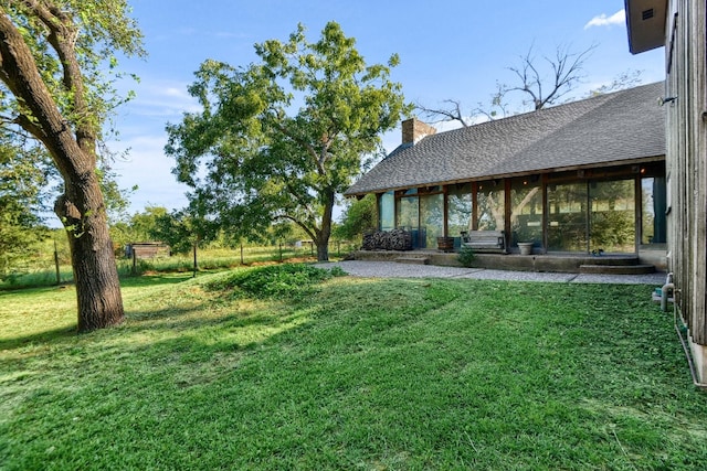 view of yard with a sunroom