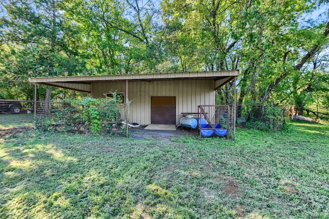 view of outbuilding featuring a yard