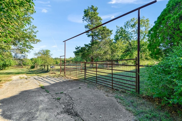 view of gate with a rural view