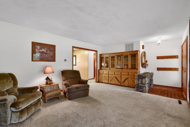 sitting room with carpet flooring and a textured ceiling