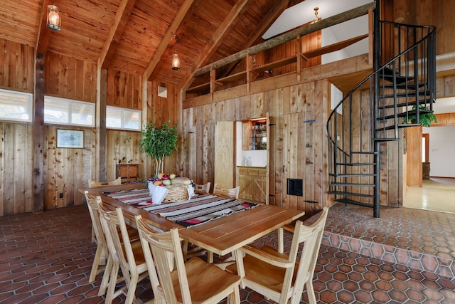 dining space with beam ceiling, high vaulted ceiling, wood ceiling, and wood walls