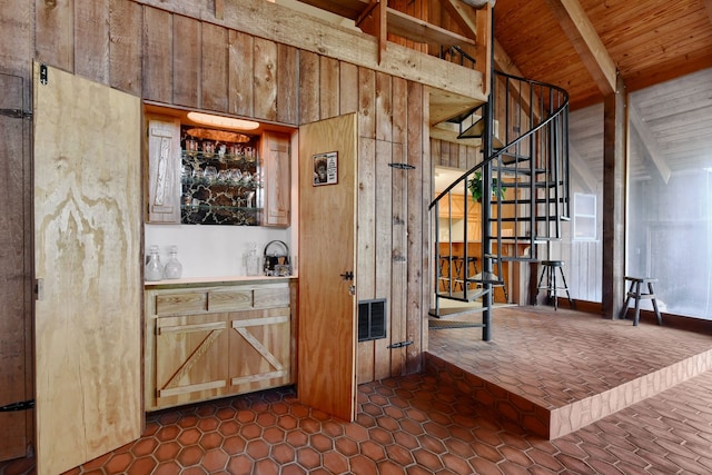 bar with wood ceiling, high vaulted ceiling, dark tile patterned flooring, beamed ceiling, and wood walls