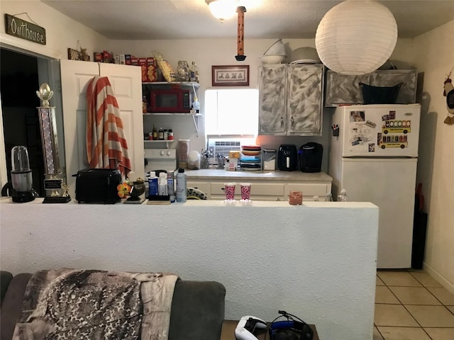 kitchen featuring light tile floors and white refrigerator