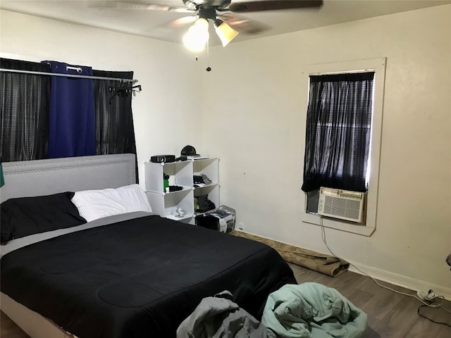 bedroom with ceiling fan and dark hardwood / wood-style floors