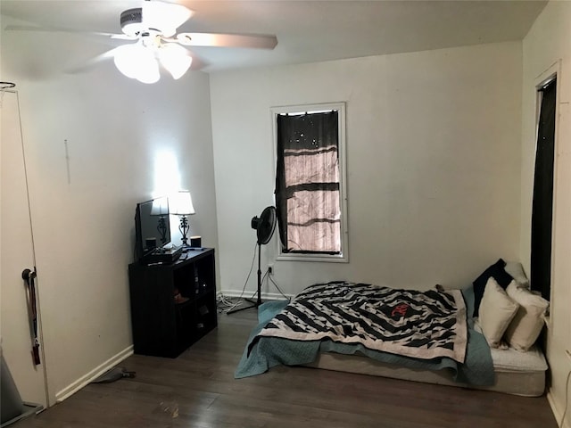 bedroom with ceiling fan and dark hardwood / wood-style flooring