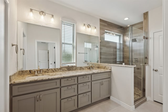 bathroom with vanity, a shower with shower door, and tile patterned flooring