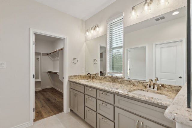 bathroom with vanity, hardwood / wood-style floors, and a healthy amount of sunlight