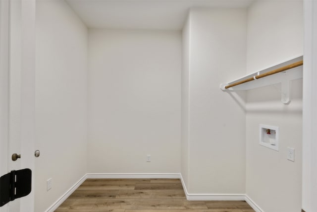 clothes washing area with washer hookup and light wood-type flooring