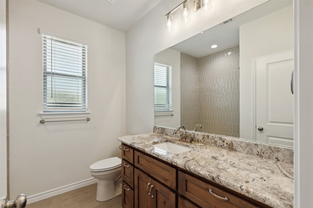 bathroom featuring toilet and vanity