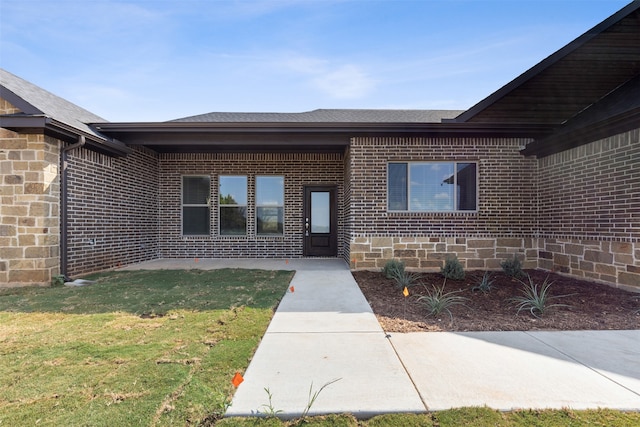 doorway to property featuring a yard and a patio area