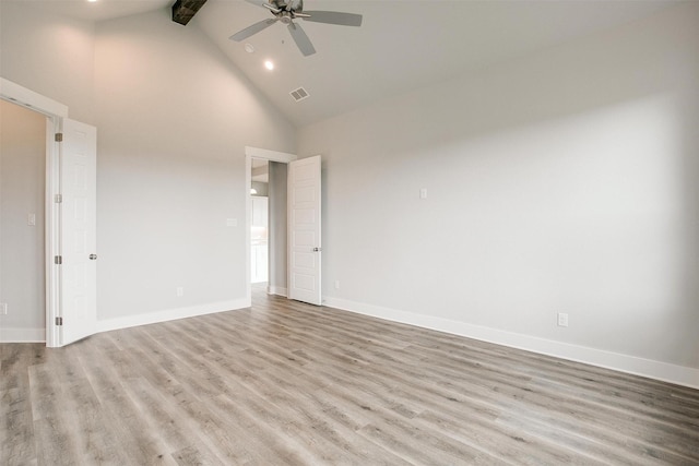 spare room with beam ceiling, ceiling fan, light hardwood / wood-style flooring, and high vaulted ceiling