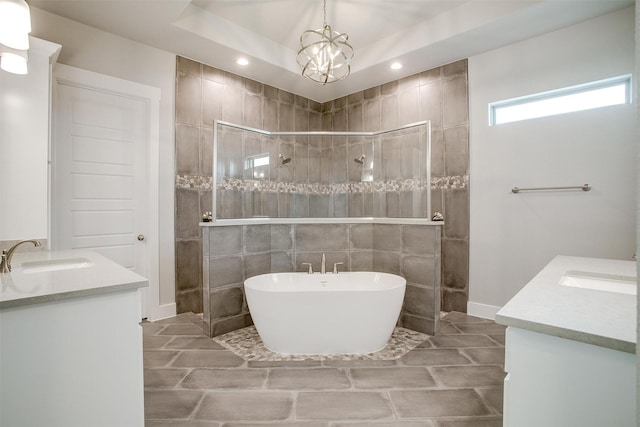 bathroom with vanity and shower with separate bathtub