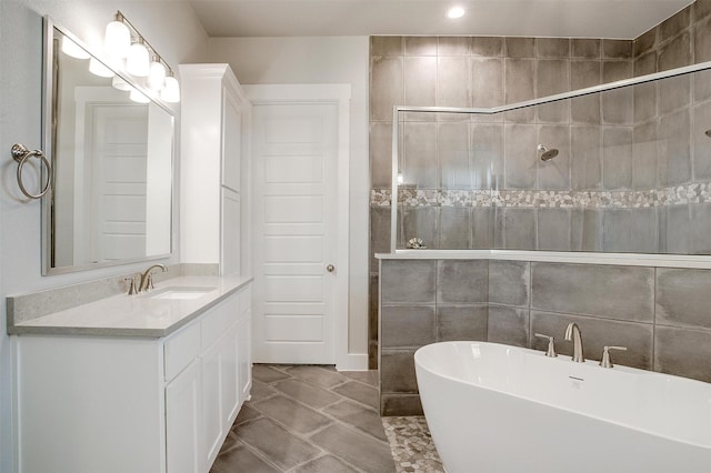 bathroom featuring vanity, separate shower and tub, and tile walls