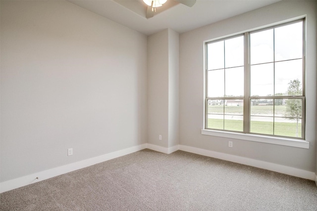 carpeted spare room with ceiling fan