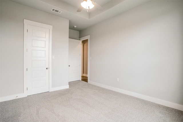 unfurnished bedroom featuring light colored carpet and ceiling fan