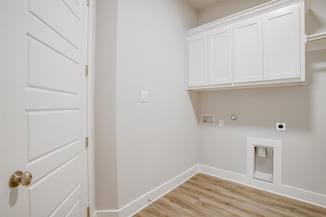 washroom featuring cabinets, washer hookup, hookup for an electric dryer, hookup for a gas dryer, and light wood-type flooring