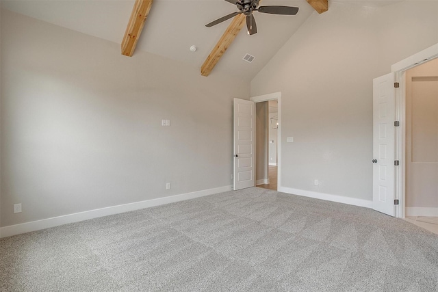 empty room featuring beamed ceiling, carpet floors, high vaulted ceiling, and ceiling fan