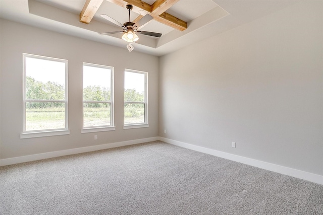 carpeted spare room with beam ceiling, ceiling fan, and coffered ceiling