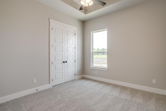 interior space featuring ceiling fan, carpet floors, and a closet