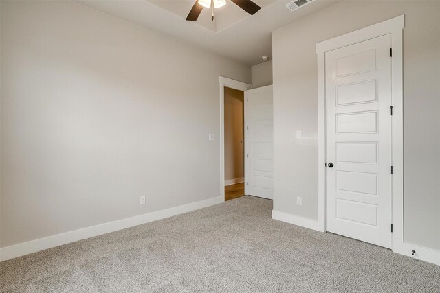 unfurnished bedroom with ceiling fan and carpet floors