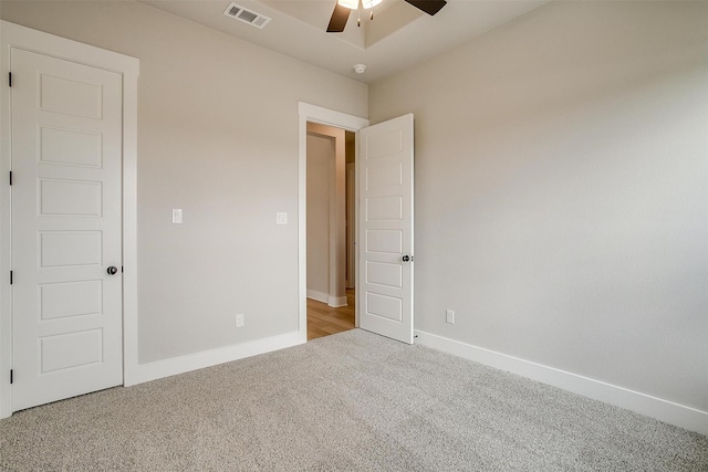 unfurnished bedroom with light carpet and ceiling fan