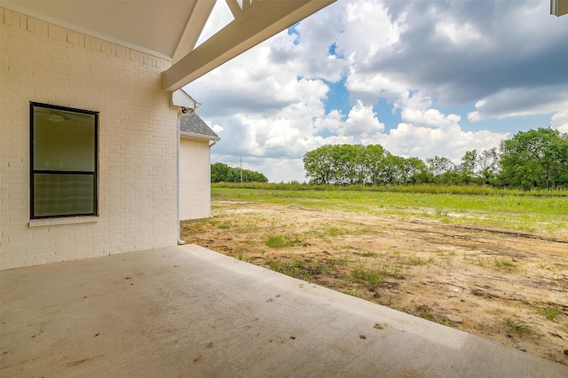 view of yard featuring a patio area and a rural view