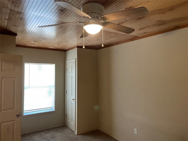 unfurnished room featuring light colored carpet, wooden ceiling, and ceiling fan