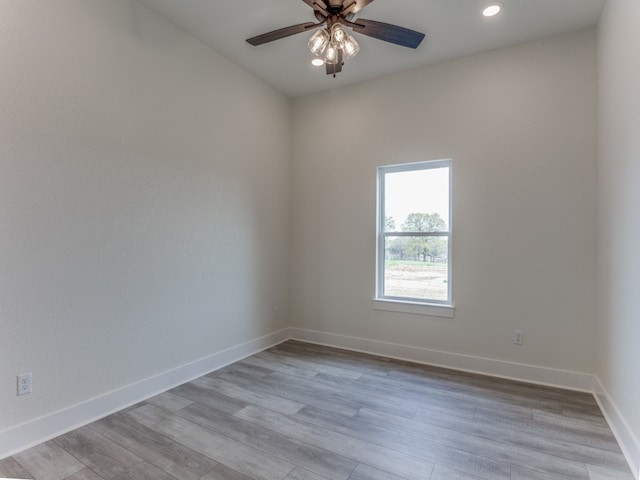 spare room featuring ceiling fan and light wood-type flooring